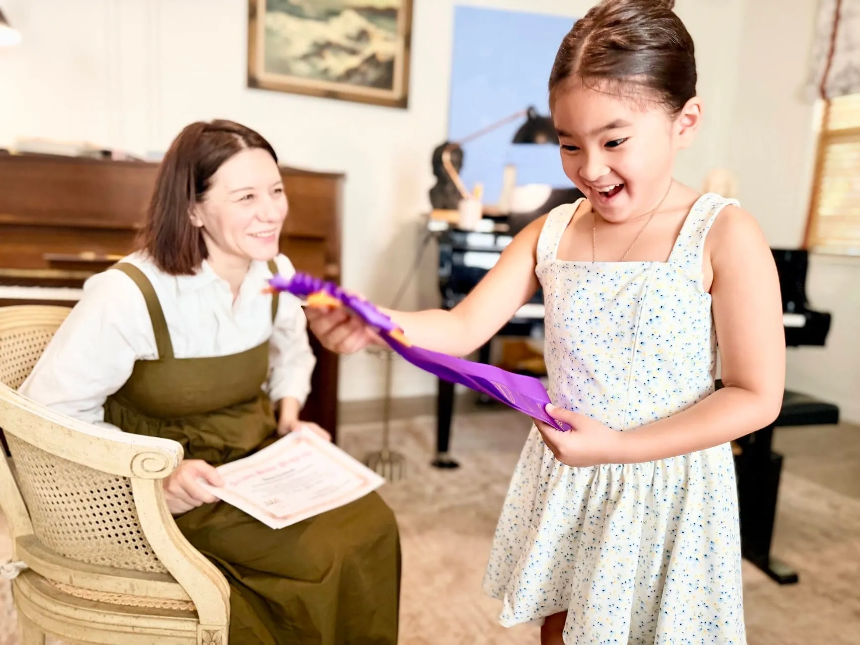 Piano student holding an Arizona Study Program award