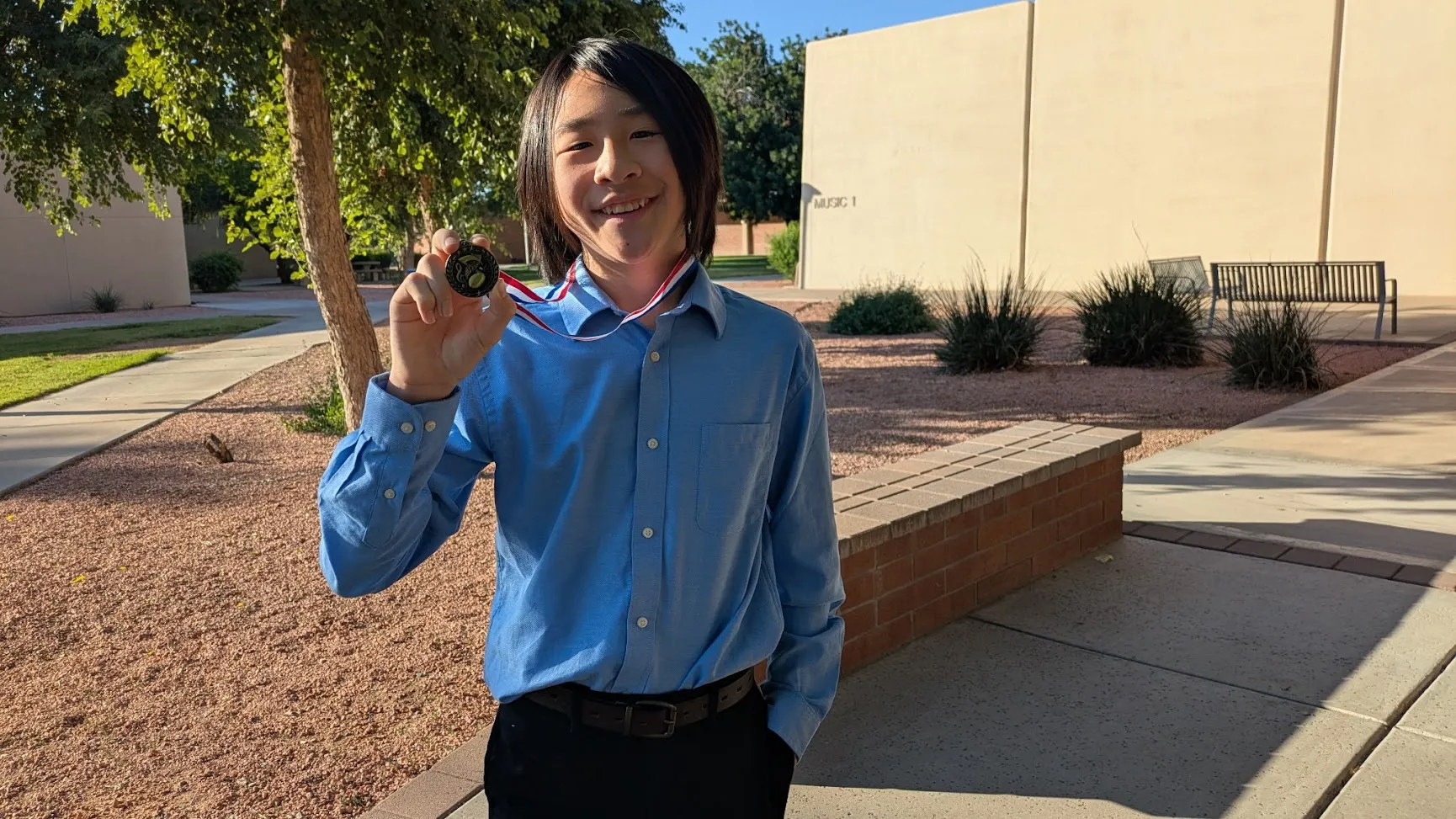 Piano student holding a PMTA Fall Piano Festival award