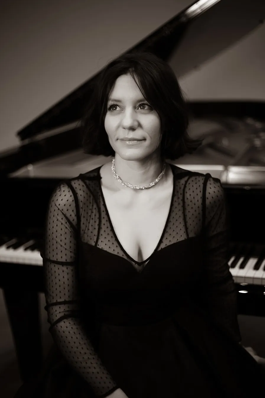 Dr. Svetlana Obregon Saens seated at the piano