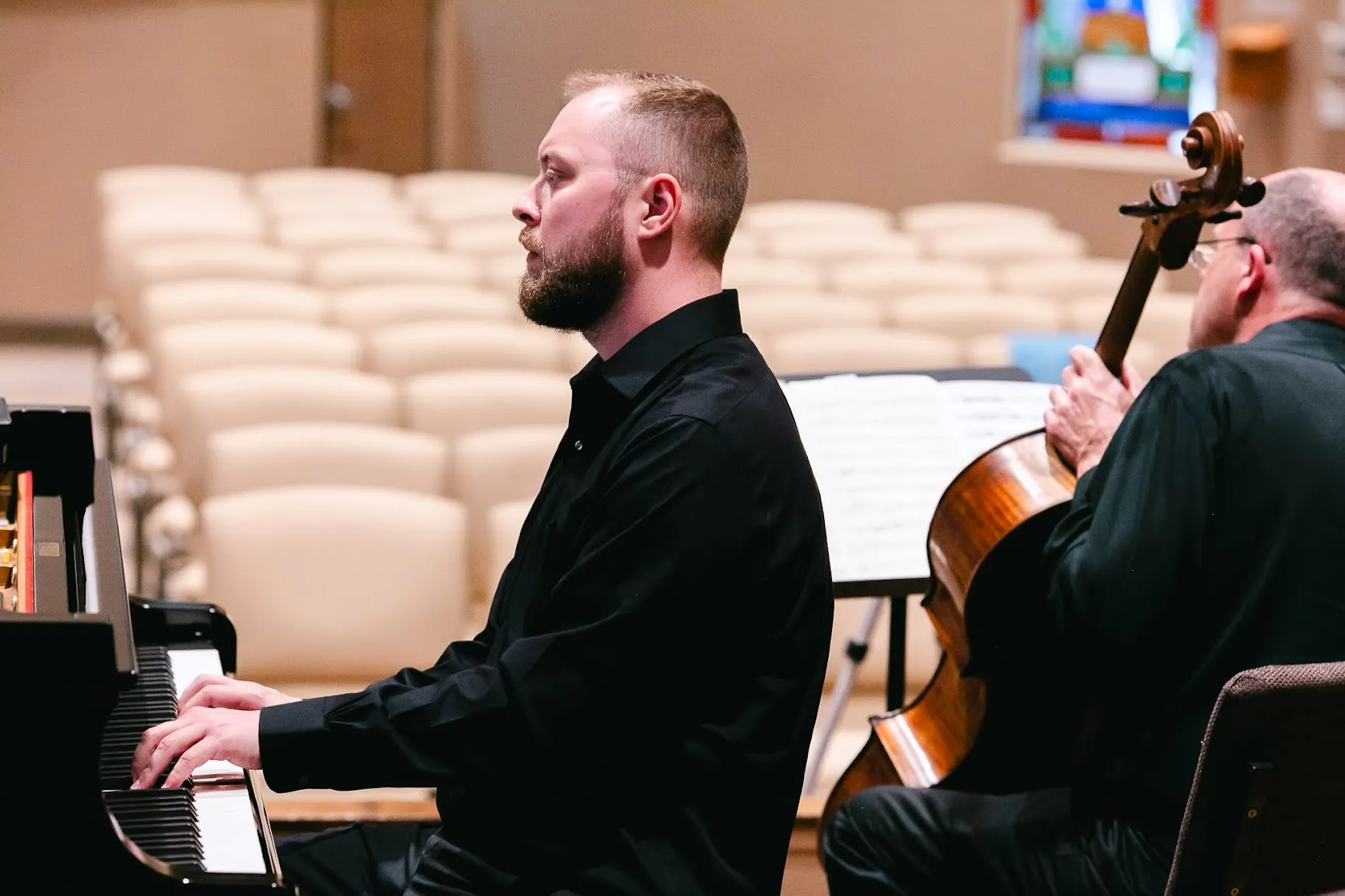 Dr. Vitaly Serebriakov seated at the piano